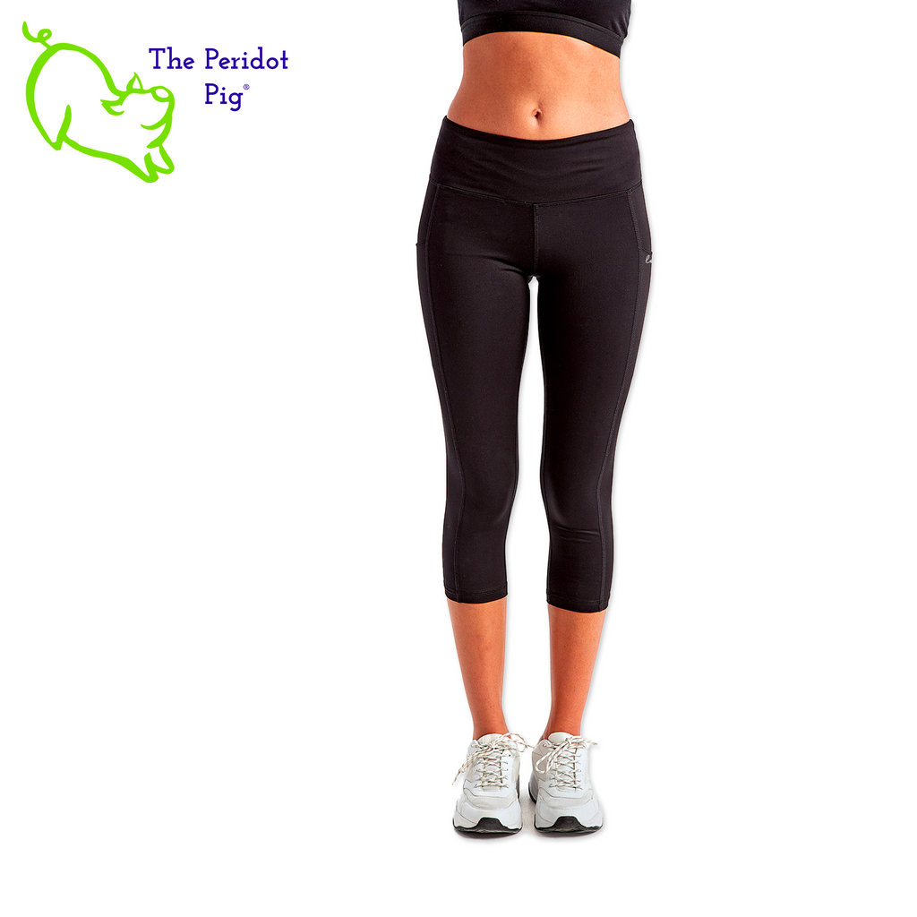 Luxuriate in luxury with the PureBliss Studios Lotus High Rise Capri Legging—super comfortable and breathable with two side pockets, an interior pocket, plus the brand logo on the back right leg in a matte vinyl and a dazzling color lotus on the back. And who wouldn't love a little "love" on the left pocket? Stretchy yet snug-fitting, enjoy the perfect yoga session! Front view shown.