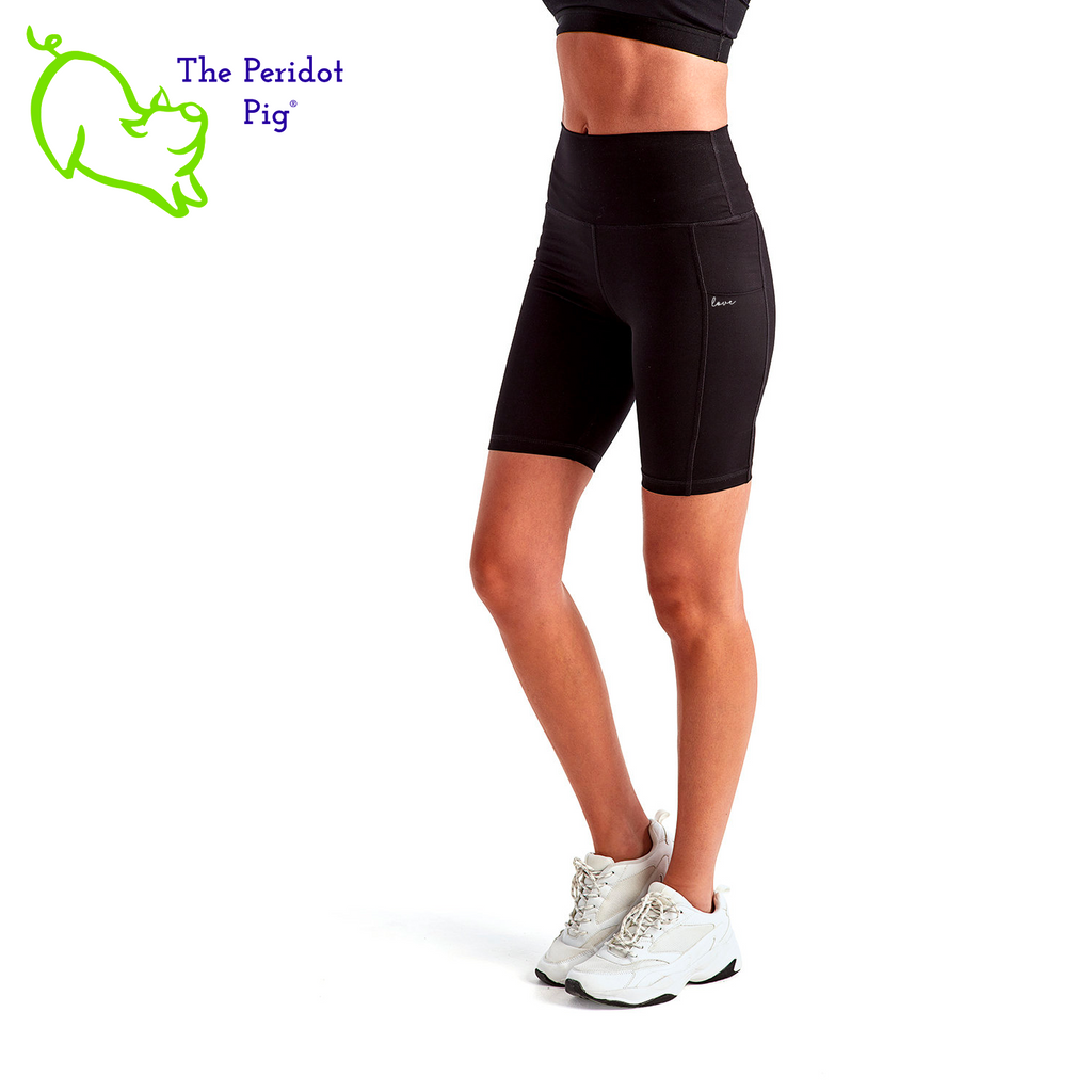 Luxuriate in luxury with the PureBliss Studios Lotus High Rise Legging Short —super comfortable and breathable with two side pockets, an interior pocket, plus the brand logo on the back right leg in a matte vinyl. And who wouldn't love a little "love" on the left pocket? Stretchy yet snug-fitting, enjoy the perfect yoga session! Three quarter view shown.