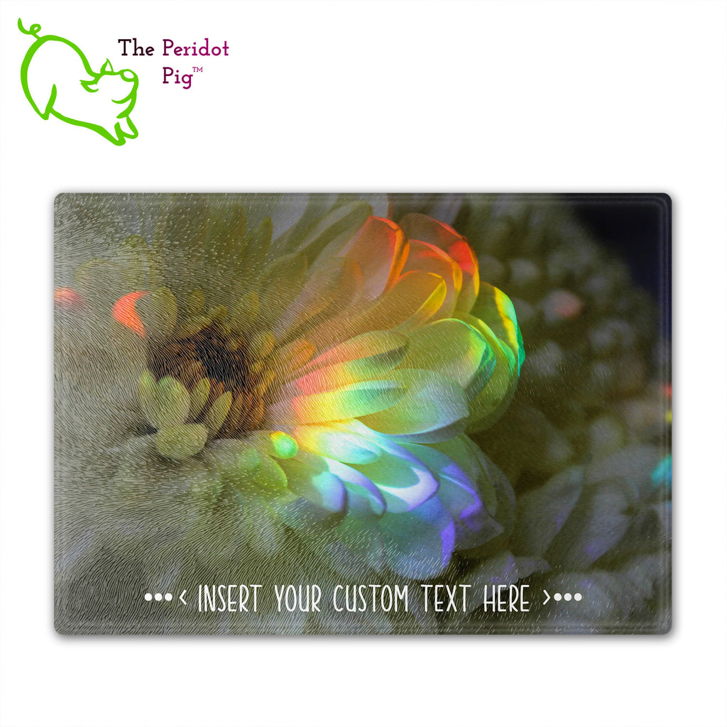 These beautiful tempered glass cutting boards are a wonderful keepsake!  They can be personalized with names, quotes or dates. This one features a large white chrysanthemum with a refracted rainbow splashed across it in a vivid and detailed print. Front view.