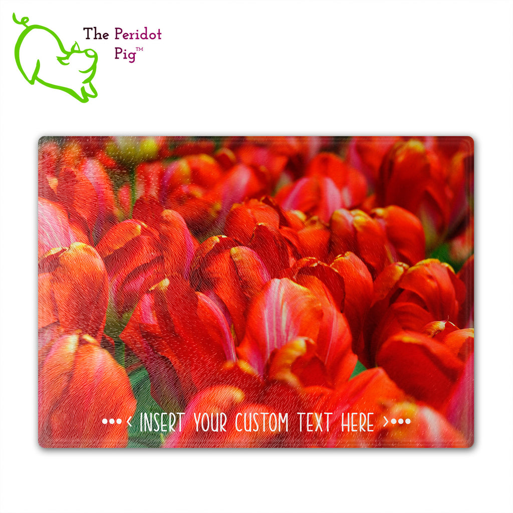 These beautiful tempered glass cutting boards are a wonderful keepsake!  They can be personalized with names, quotes or dates. This one features a field of bright red tulips in a vivid and detailed print. Perfect for cutting or using as a serving board! Front view.