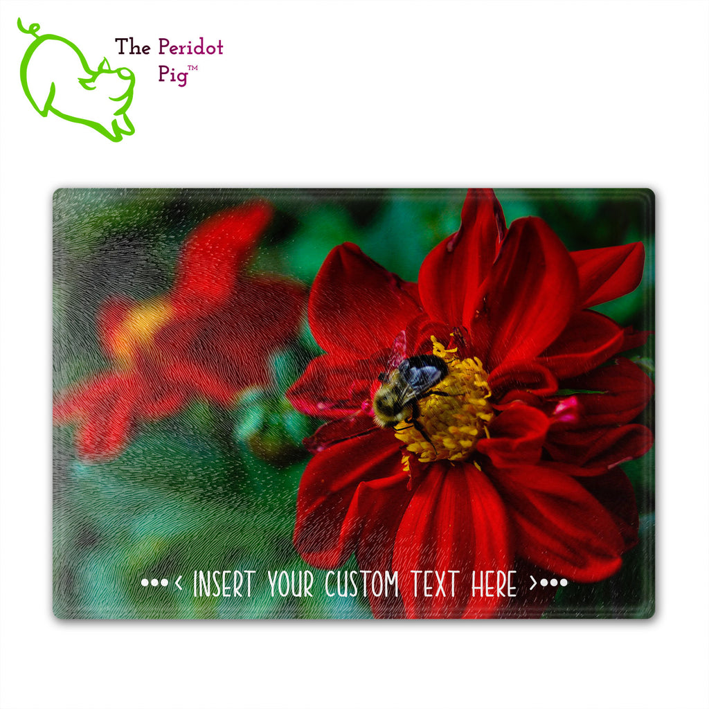 These beautiful tempered glass cutting boards are a wonderful keepsake!  They can be personalized with names, quotes or dates. This one features a bright red flower with a cute little honey bee in a vivid and detailed print. Perfect for cutting or using as a serving board! Front view.