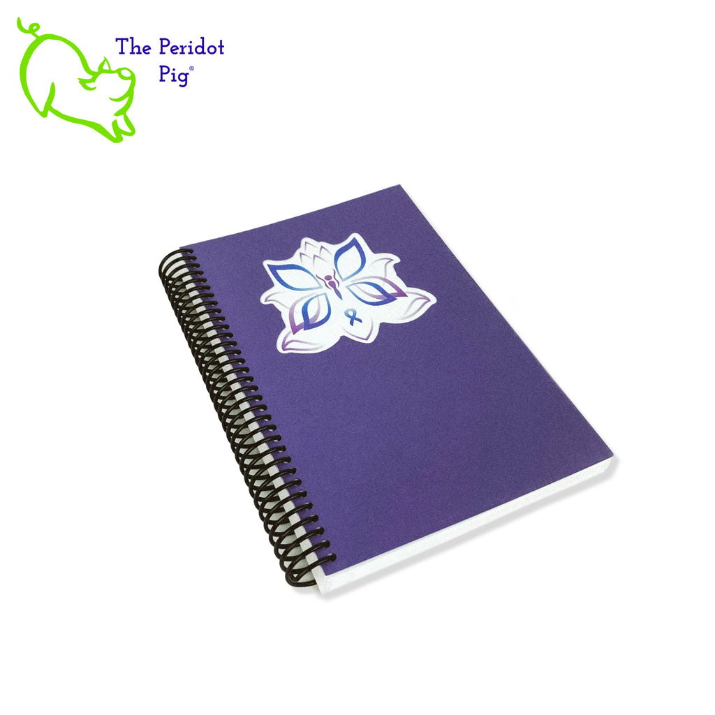 The journal is printed on 32 bond 5.5 x 8" paper which is a joy to write in. Colorful pages and illustrations help lay out your monthly, weekly and daily plans. The front cover is a beautiful wisteria purple with a cutout around her logo. The back is a navy cover stock. All of the 250 pages are bound in a spiral coil allowing the journal to lie flat or fold back.  Front cover view.