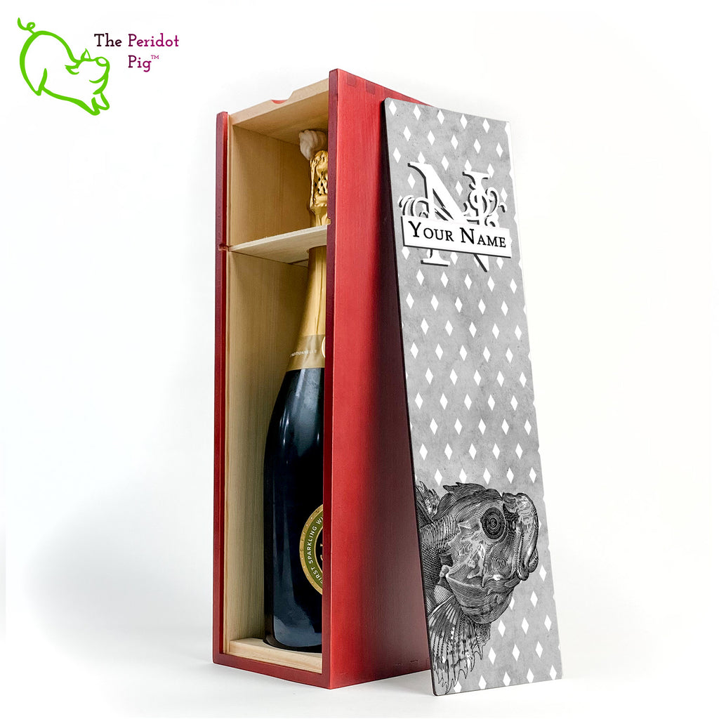 The wine box front panel is decorated in a glossy, detailed print with a white monogram and space for a customized name. This model has a smokey gray background with a pattern of white diamond shapes. In the foreground is a large black line drawing of a fish. Cherry finish showing the interior and a sample wine bottle.