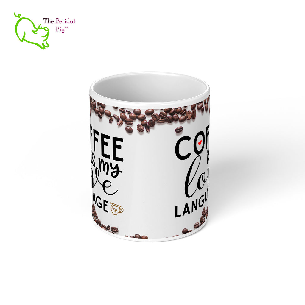 This 11 oz coffee mug is the perfect gift for the coffee lover in your life. The printed saying states, "Coffee is my love language" nestled amongst a field of coffee beans. Center view.