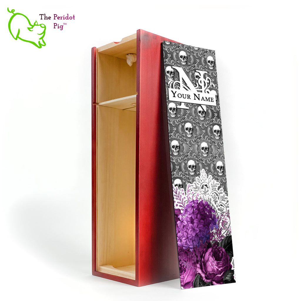 A gift wine box with decorated panel. The front panel is decorated in a glossy, detailed print with a monogram and space for a customized name. This model has a background of Victorian skulls with a bouquet of purple flowers and lace. Inside view with no bottle. Shown in cherry finish.