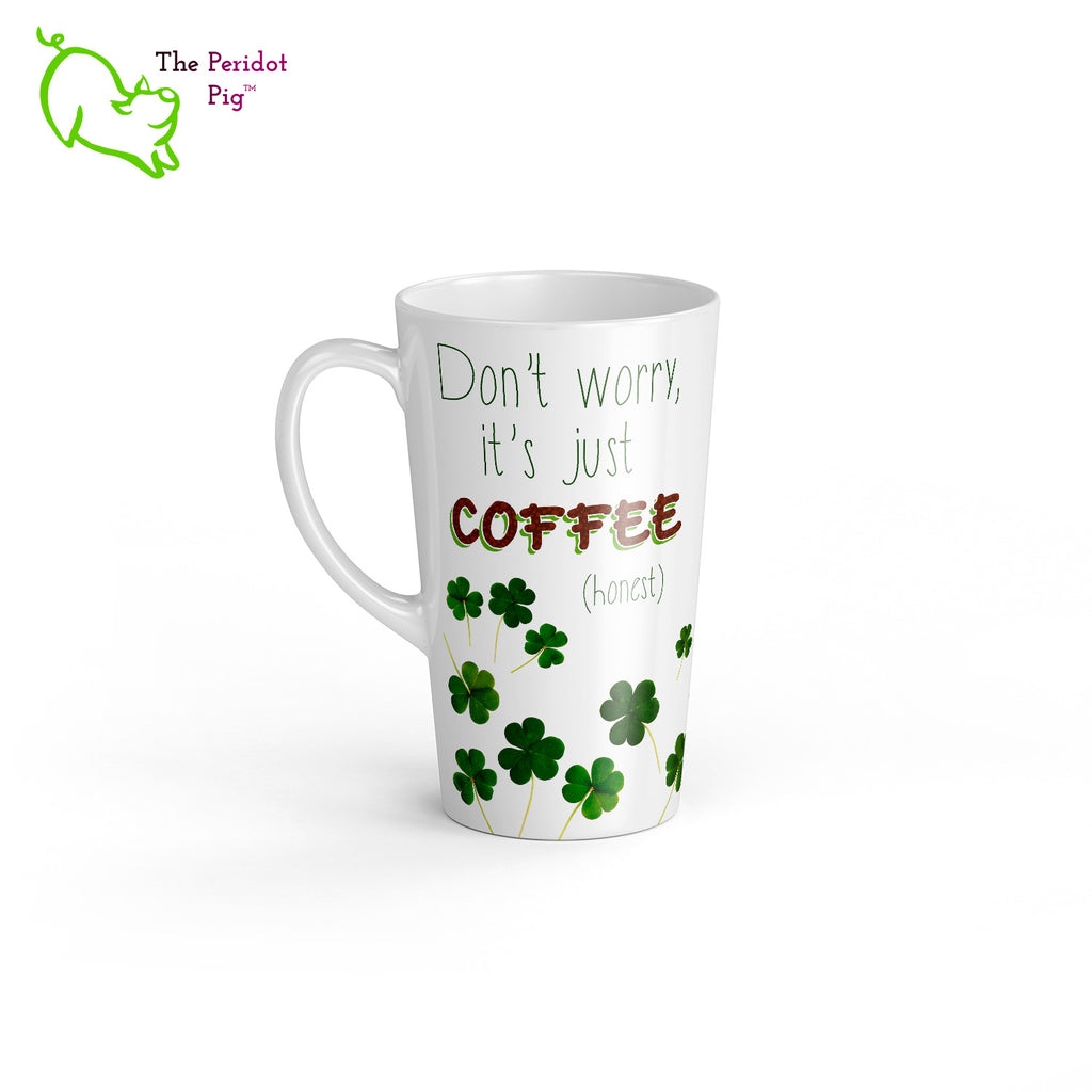 A 17 oz white latte mug. Perfect for an Irish Coffee or a regular cup o'joe. The caption reads, "Don't worry, it's just coffee (honest)" set amid a collection of shamrocks. Left view.