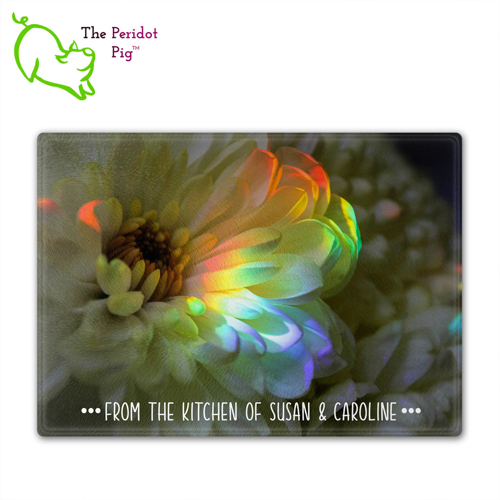 These beautiful tempered glass cutting boards are a wonderful keepsake!  They can be personalized with names, quotes or dates. This one features a large white chrysanthemum with a refracted rainbow splashed across it in a vivid and detailed print. Front view with sample text.