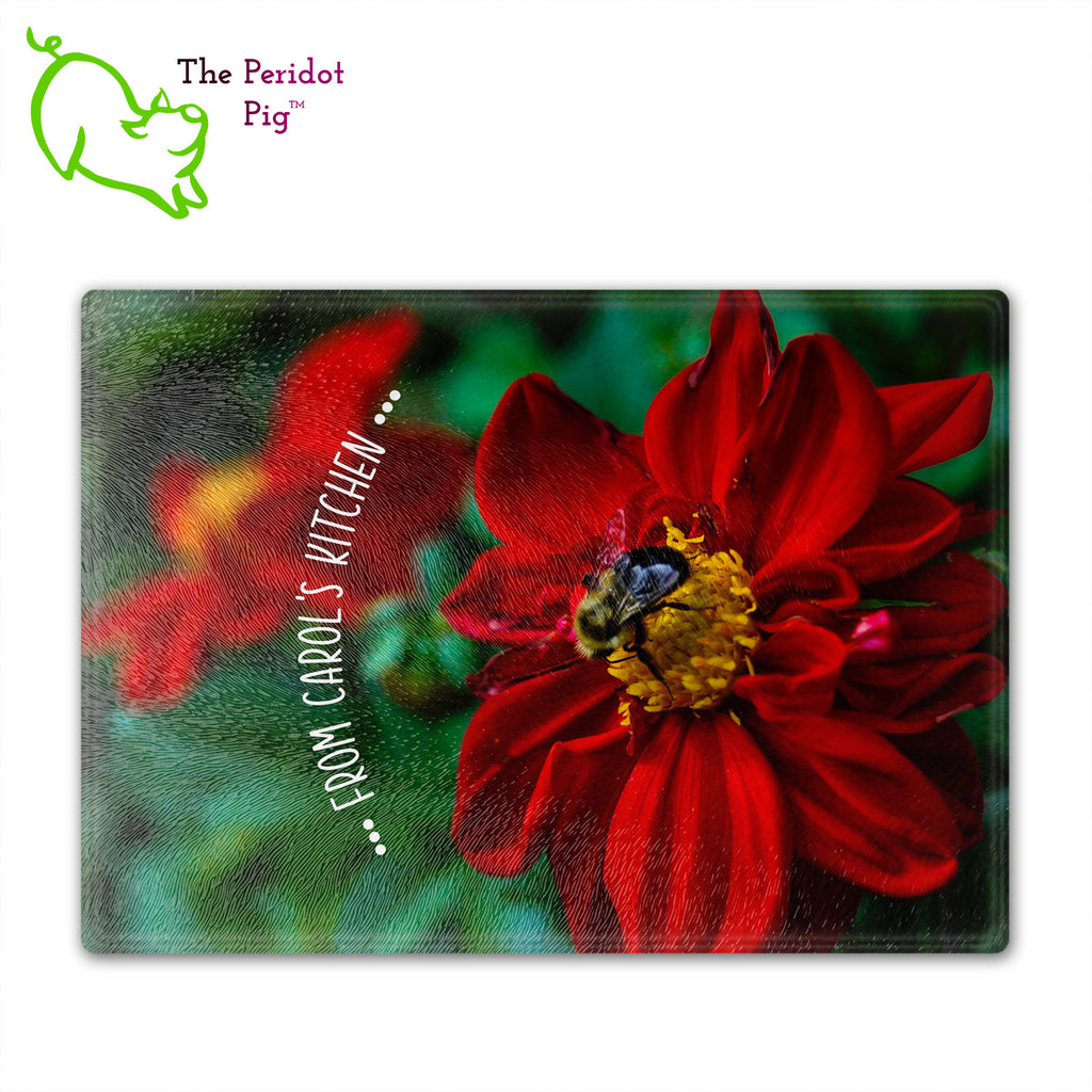 These beautiful tempered glass cutting boards are a wonderful keepsake!  They can be personalized with names, quotes or dates. This one features a bright red flower with a cute little honey bee in a vivid and detailed print. Perfect for cutting or using as a serving board! Front view with sample text.