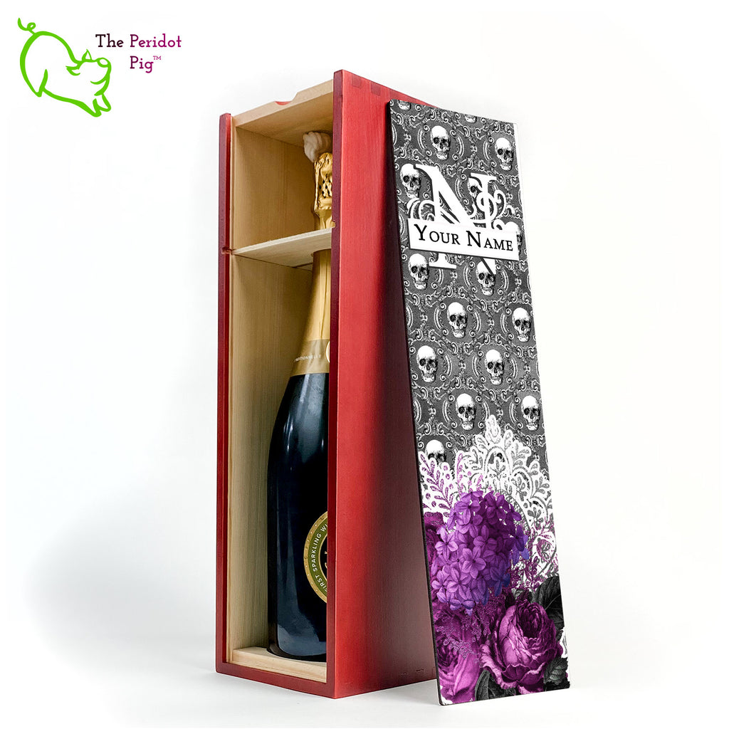 A gift wine box with decorated panel. The front panel is decorated in a glossy, detailed print with a monogram and space for a customized name. This model has a background of Victorian skulls with a bouquet of purple flowers and lace. Inside view with an example bottle. Shown in cherry finish.