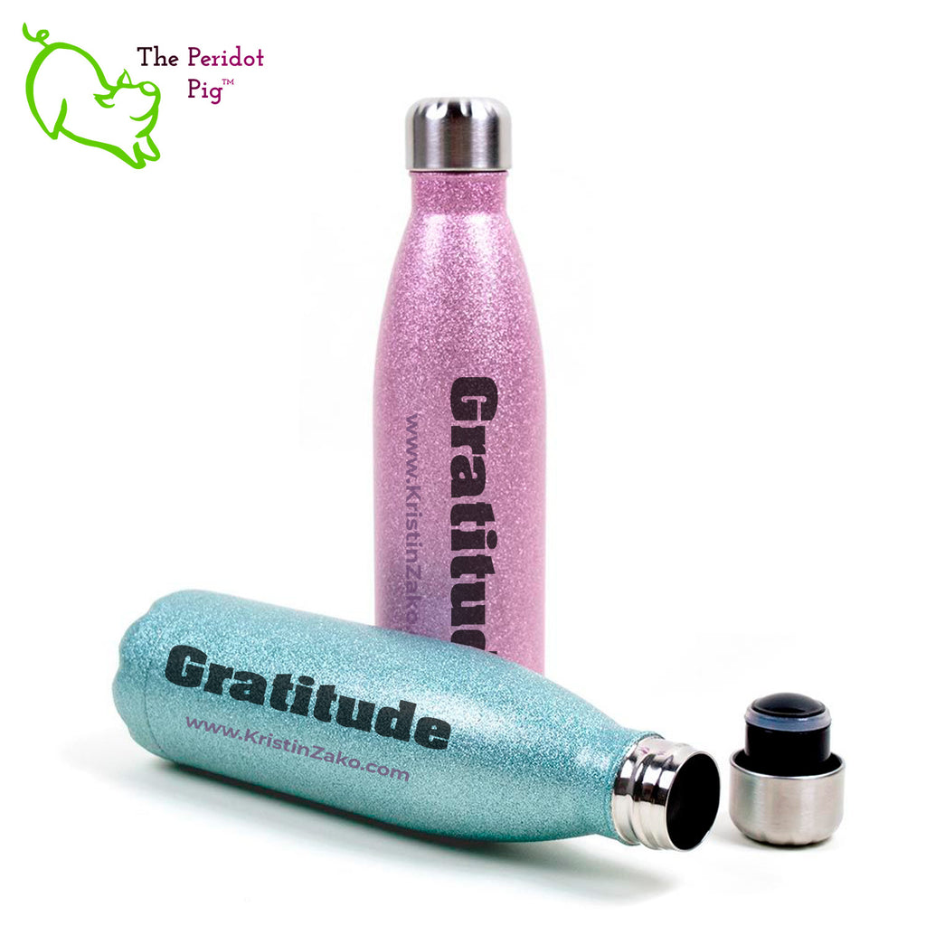 This 17 oz glitter cola-shaped water bottle features the word "Gratitude" in bold black lettering on both front and back. It has a screw top with a replaceable gasket and easily fits in cupholders or your backpack. Multi view showing pink and turquoise.
