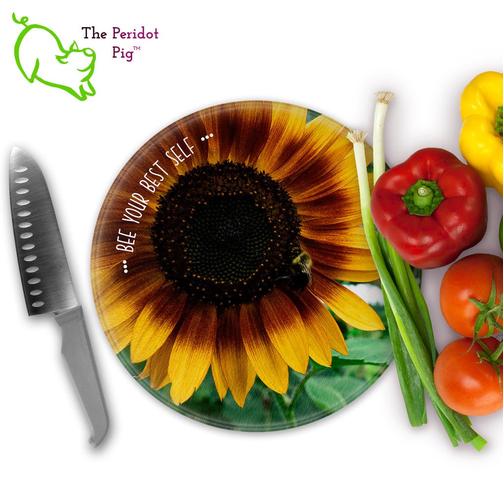 This beautiful tempered glass cutting board is a wonderful keepsake!  It can be personalized with names, quotes or dates. This one features a bright yellow sunflower with a cute little honey bee in a vivid and detailed print. Perfect for cutting or using as a serving board! Front view with veggies.