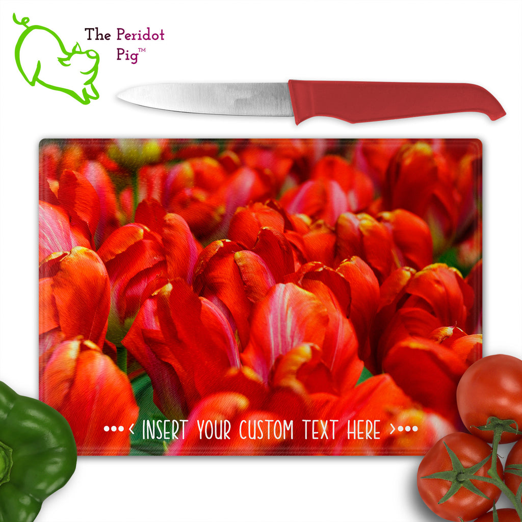 These beautiful tempered glass cutting boards are a wonderful keepsake!  They can be personalized with names, quotes or dates. This one features a field of bright red tulips in a vivid and detailed print. Perfect for cutting or using as a serving board! Front view shown with cutlery.