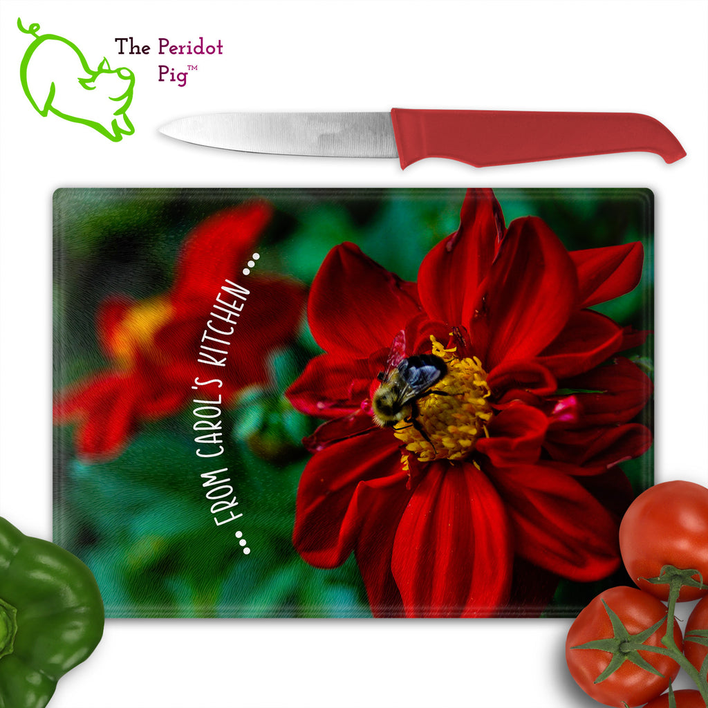 These beautiful tempered glass cutting boards are a wonderful keepsake!  They can be personalized with names, quotes or dates. This one features a bright red flower with a cute little honey bee in a vivid and detailed print. Perfect for cutting or using as a serving board! Front view with veggies.