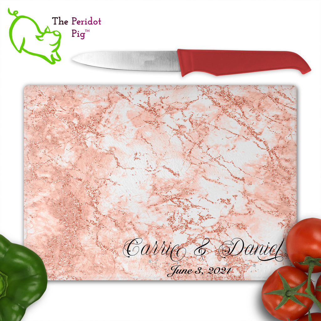 These beautiful tempered glass cutting boards are a wonderful keepsake!  They can be personalized with names, quotes or dates. These feature swirling marbles in rose gold and glitter foil in a vivid and detailed print. We prefer a scrolling script for the personalization in this design. There is also a little bling under the name included too. Front view with sample text with veggies. Style C