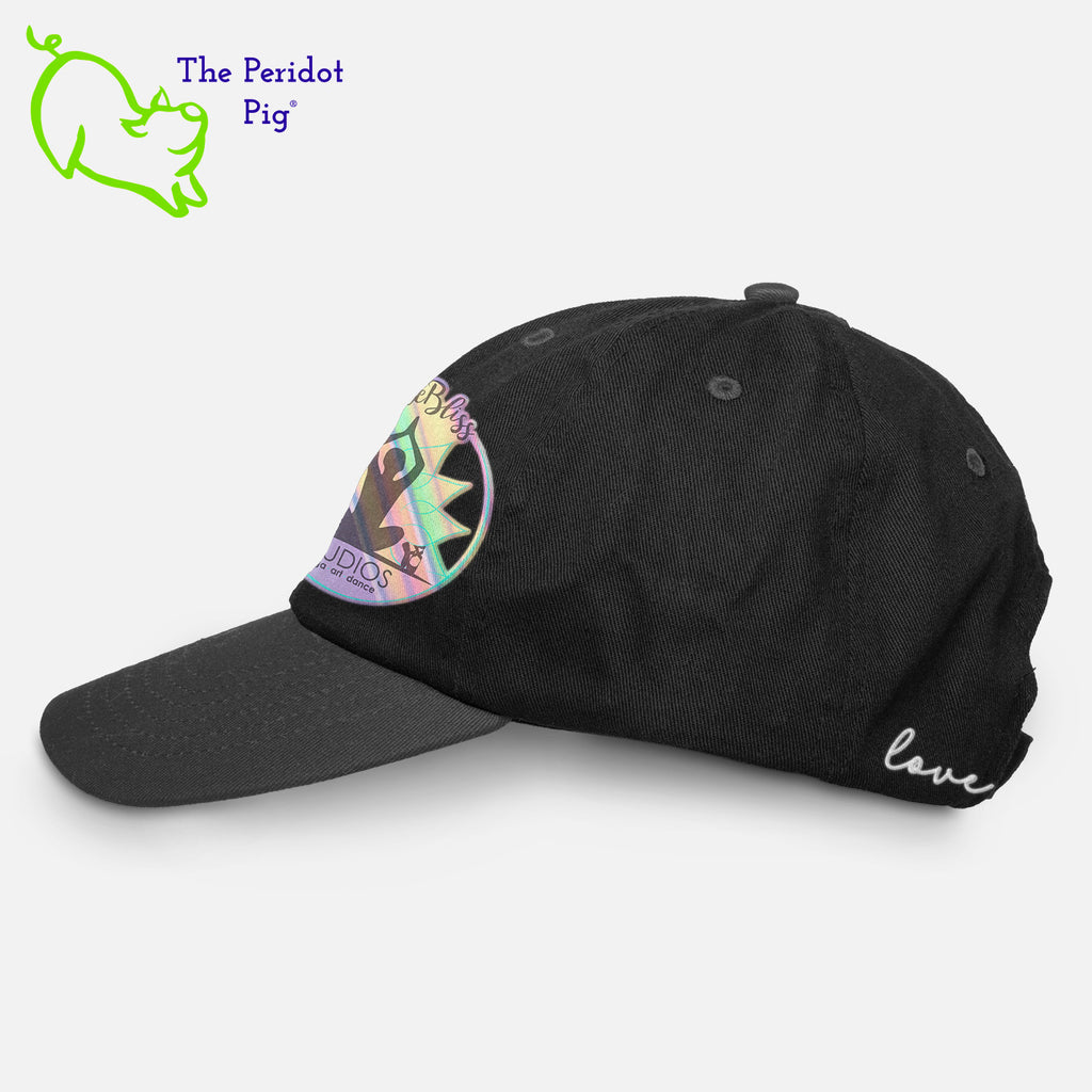 This 6-Panel twill unstructured cap is perfect for a bit of shade or to pull back a pony tail. The PureBliss Studios logo is printed on the front in a fun hologram print. A little "love" is on the back left side as well. Left view shown in black.