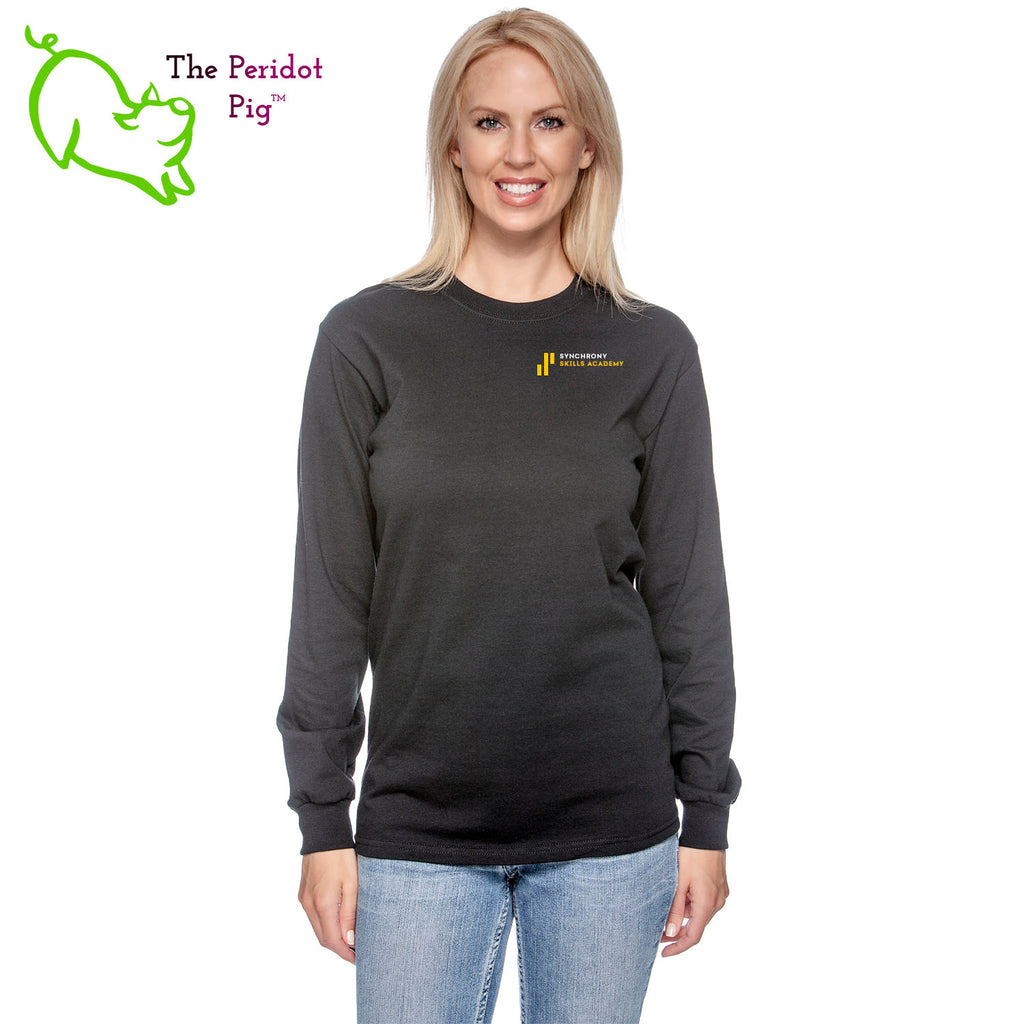 The Synchrony Financial Skills Academy Logo long sleeve shirt is made of 100% super soft cotton. The front features a small version of the logo on the left pocket area. The back has a larger version of the logo. Front view in black on model.