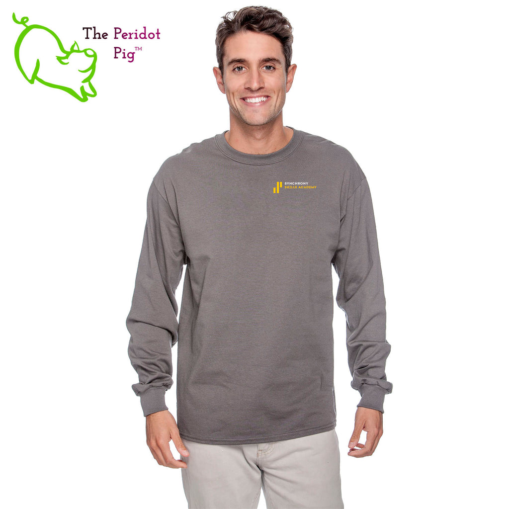 The Synchrony Financial Skills Academy Logo long sleeve shirt is made of 100% super soft cotton. The front features a small version of the logo on the left pocket area. The back has a larger version of the logo. Front view in charcoal on model.