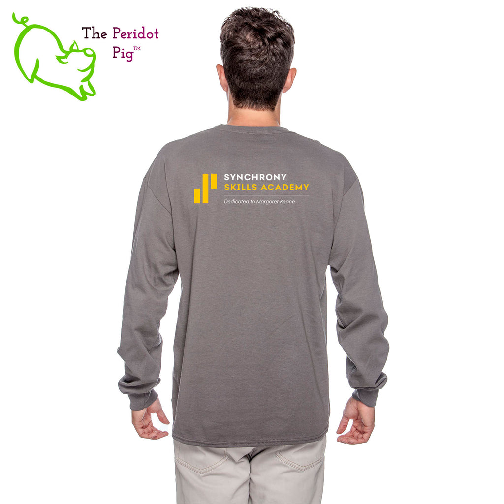 The Synchrony Financial Skills Academy Logo long sleeve shirt is made of 100% super soft cotton. The front features a small version of the logo on the left pocket area. The back has a larger version of the logo. Back view in charcoal on model.