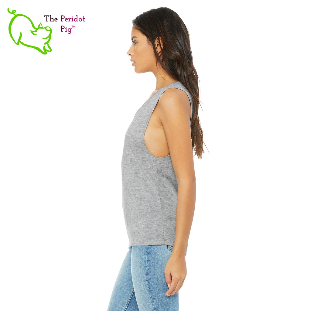 This comfortable muscle tank is soft and flowy with low cut armholes for a relaxed look. The shirt features Kristin Zako's logo on the front in bright blue and purple colors. The back is blank. The print is a translucent, faded "vintage" look due to the blend of the fabric. Side view in Heather Athletic.