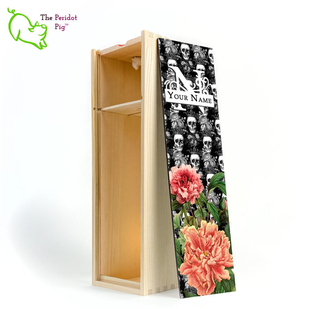 The front panel is decorated in a glossy, detailed print with a monogram and space for a customized name. This model has a background of Victorian skulls wearing a crown. in the foreground, there are two colorful peonies with green foliage. Front view in natural showing the interior of the box.