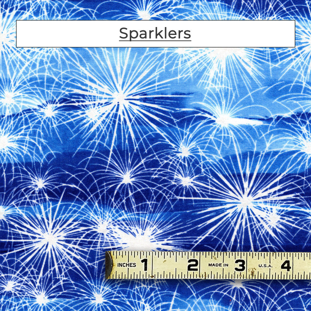 Sparklers and fireworks are always so festive. In this pattern, there are white fireworks on a blue cloudy background. 
