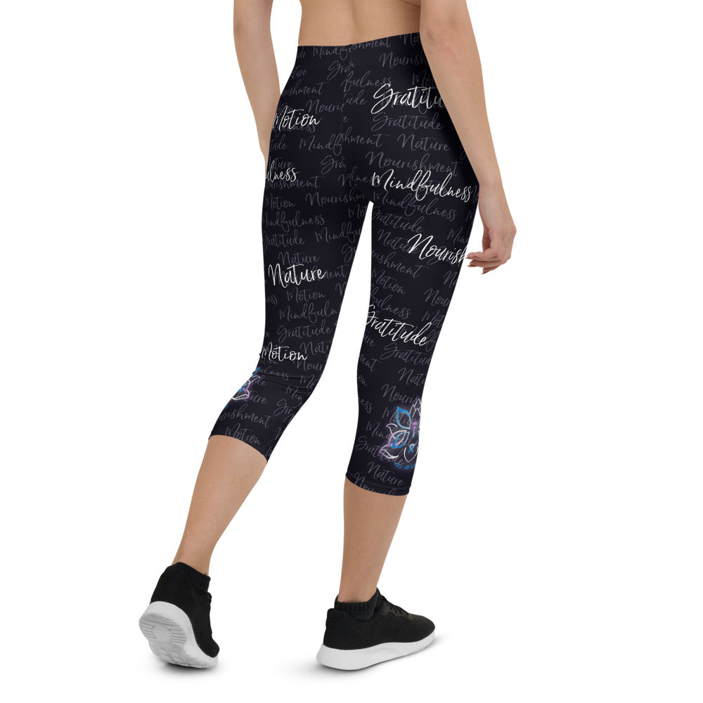 These Kristin Zako capri leggings are filled with her four pillars phrases and topped off with her logo on each side. They are super soft and comfortable. Shown in black, back view.