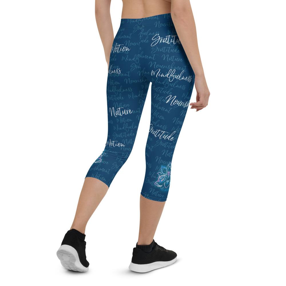 These Kristin Zako capri leggings are filled with her four pillars phrases and topped off with her logo on each side. They are super soft and comfortable. Shown in blue, back view.