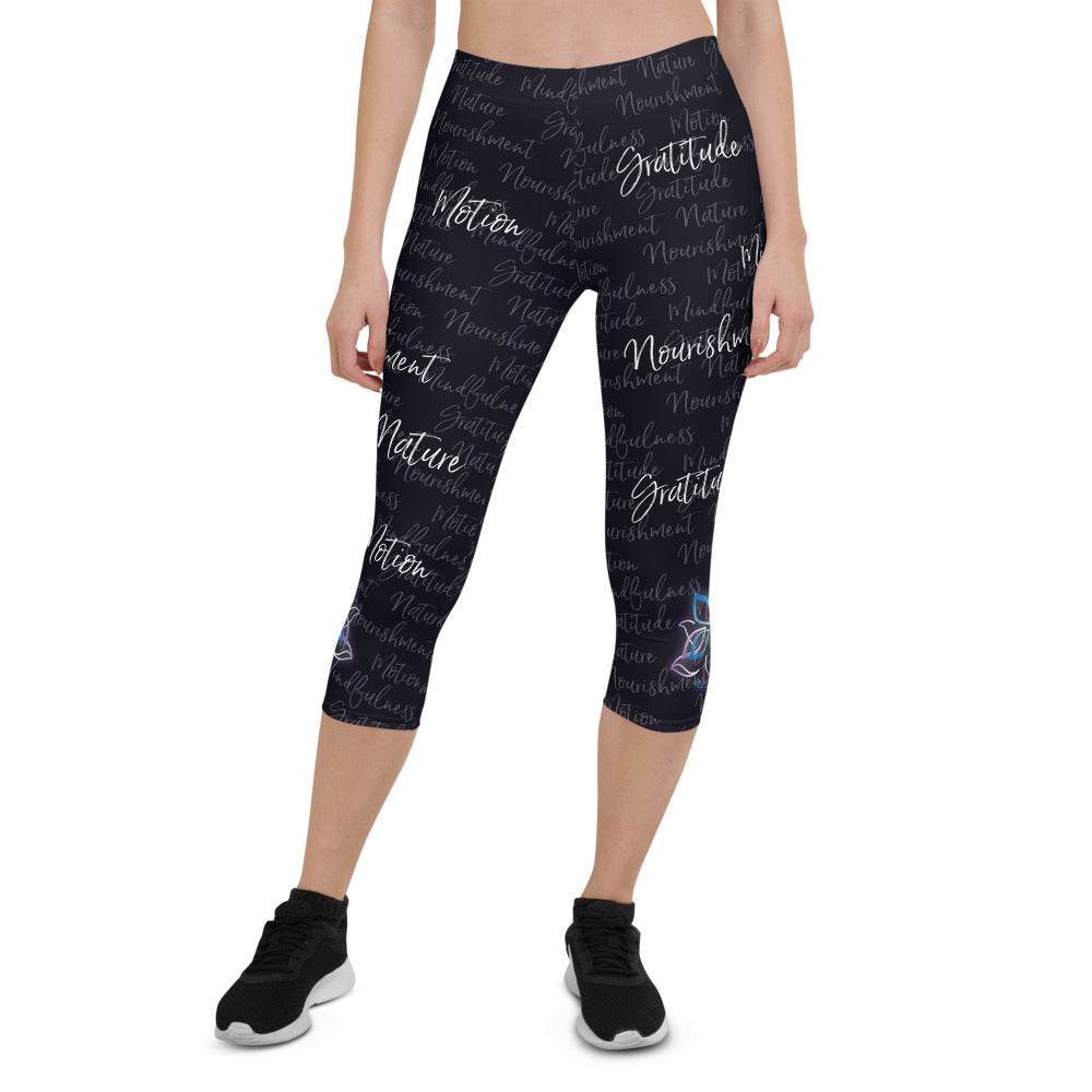 These Kristin Zako capri leggings are filled with her four pillars phrases and topped off with her logo on each side. They are super soft and comfortable. Shown in black, front view.