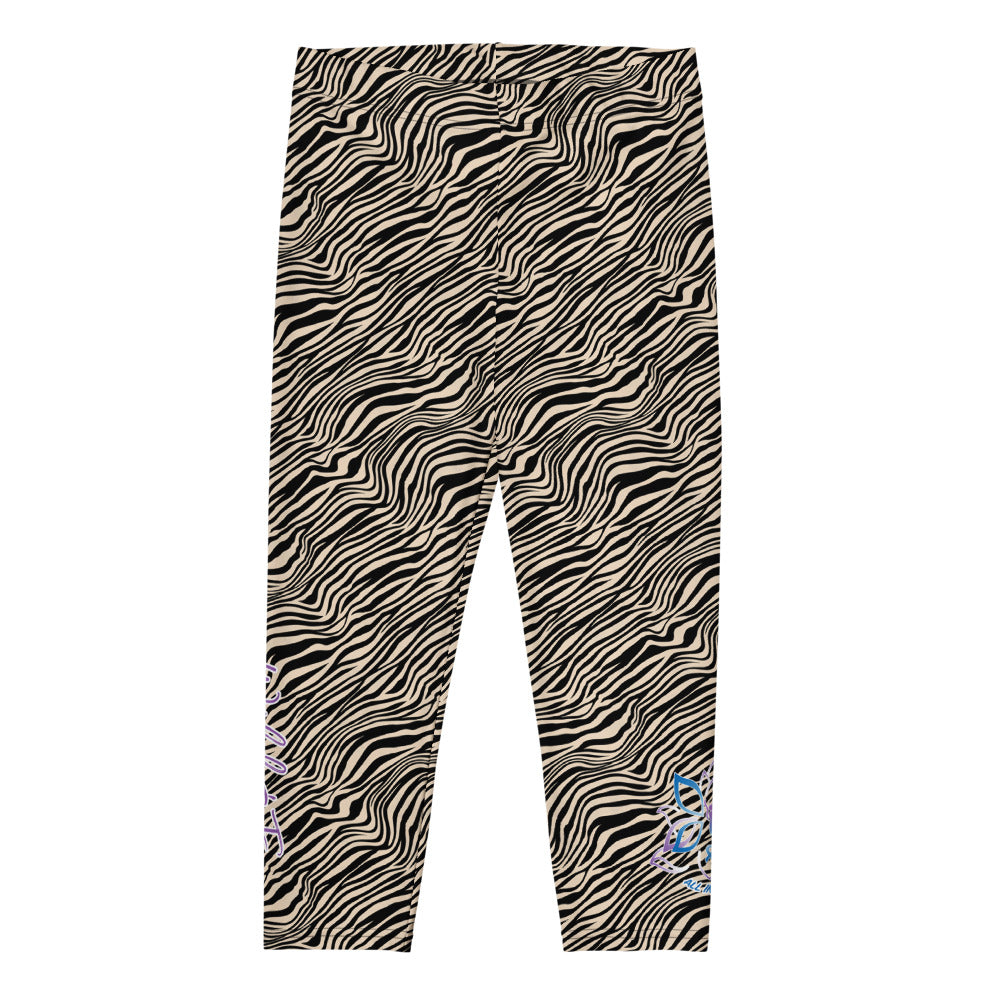 Kristin Zako embodies the "Wild & Free" spirit of her print capri leggings. These are printed in vivid color with a stylized cheetah print. The words, "WILD & FREE" are down the right leg and you'll find Kristin's logo on the lower left leg. Zebra style - Flat view.