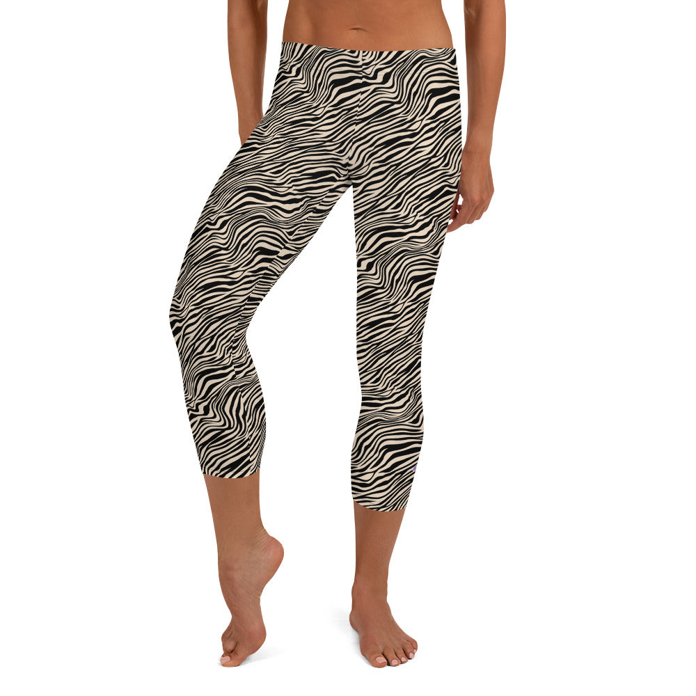 Kristin Zako embodies the "Wild & Free" spirit of her print capri leggings. These are printed in vivid color with a stylized cheetah print. The words, "WILD & FREE" are down the right leg and you'll find Kristin's logo on the lower left leg. Zebra style - Front view.
