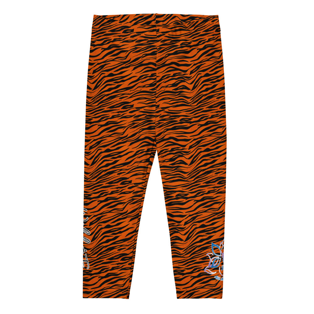 Kristin Zako embodies the "Wild & Free" spirit of her print capri leggings. These are printed in vivid color with a stylized cheetah print. The words, "WILD & FREE" are down the right leg and you'll find Kristin's logo on the lower left leg. Tiger style - flat view.