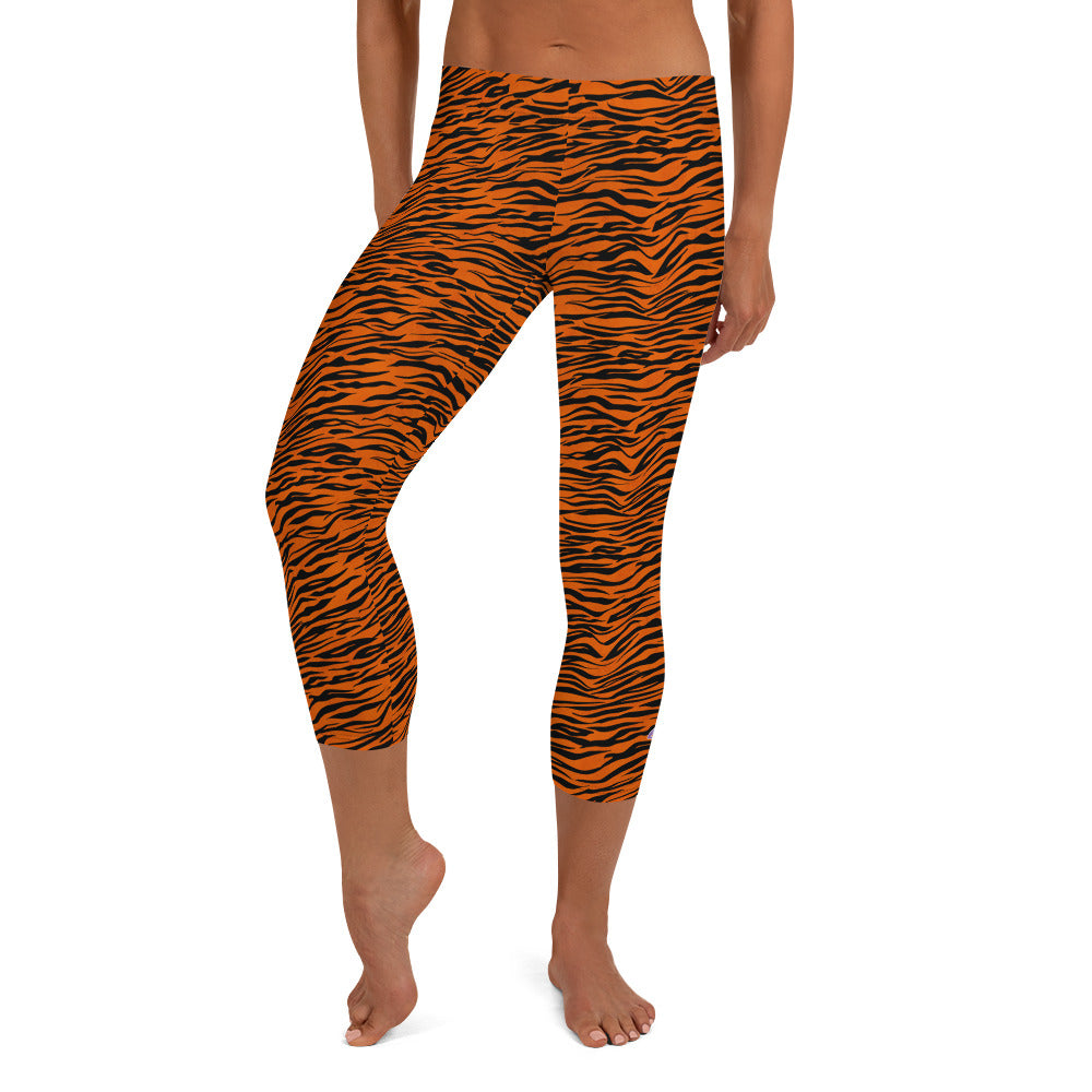 Kristin Zako embodies the "Wild & Free" spirit of her print capri leggings. These are printed in vivid color with a stylized cheetah print. The words, "WILD & FREE" are down the right leg and you'll find Kristin's logo on the lower left leg. Tiger style - front view.