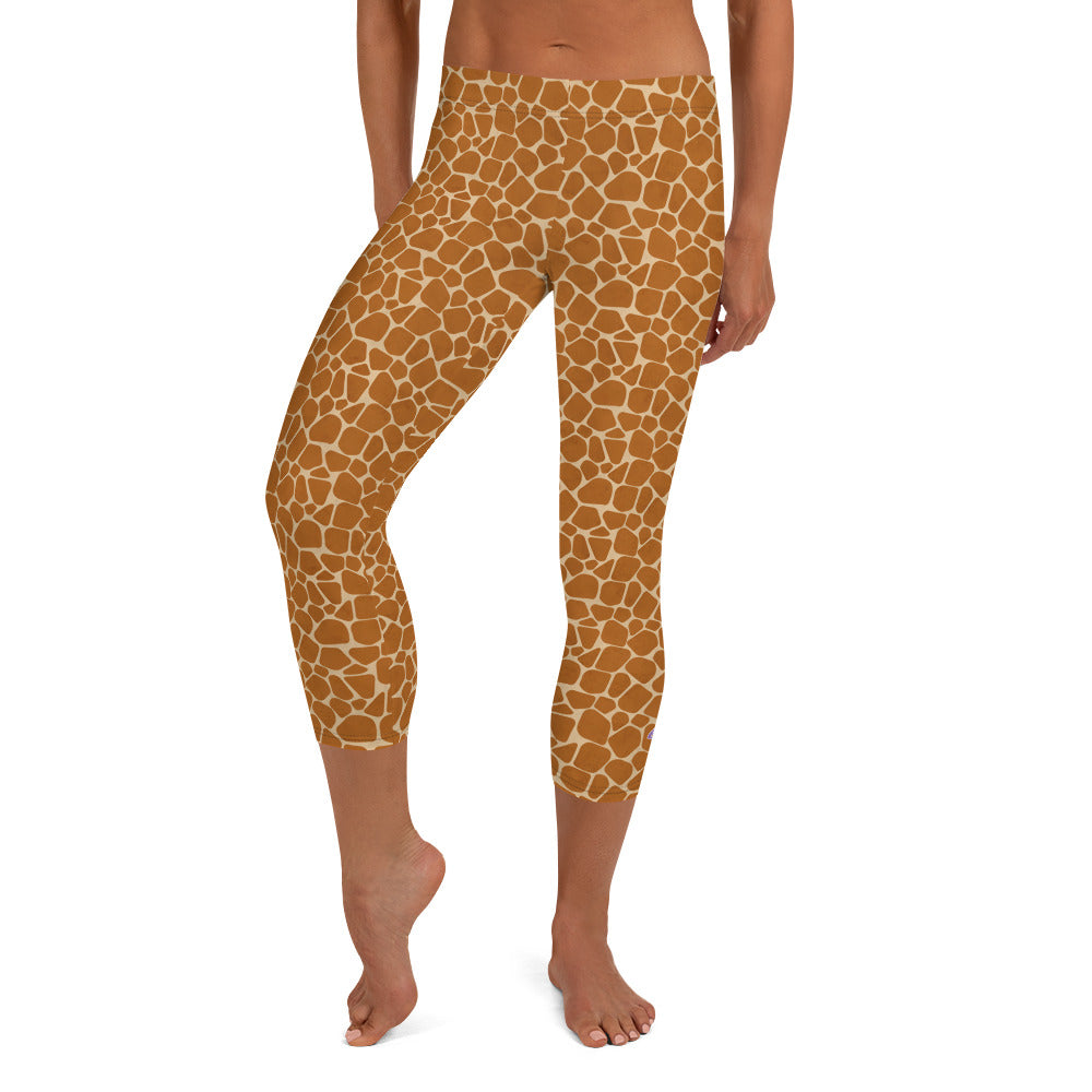 Kristin Zako embodies the "Wild & Free" spirit of her print capri leggings. These are printed in vivid color with a stylized cheetah print. The words, "WILD & FREE" are down the right leg and you'll find Kristin's logo on the lower left leg. Giraffe style - front view.