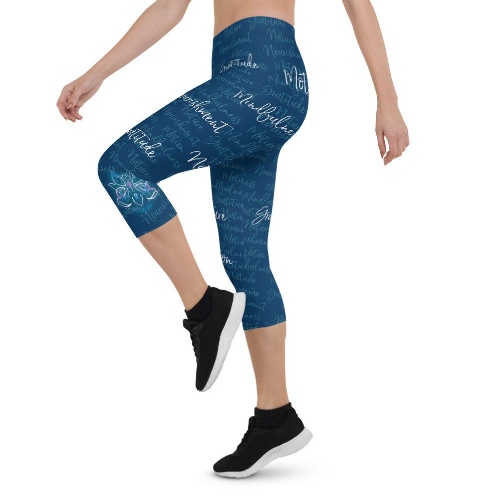 These Kristin Zako capri leggings are filled with her four pillars phrases and topped off with her logo on each side. They are super soft and comfortable. Shown in blue, left view.