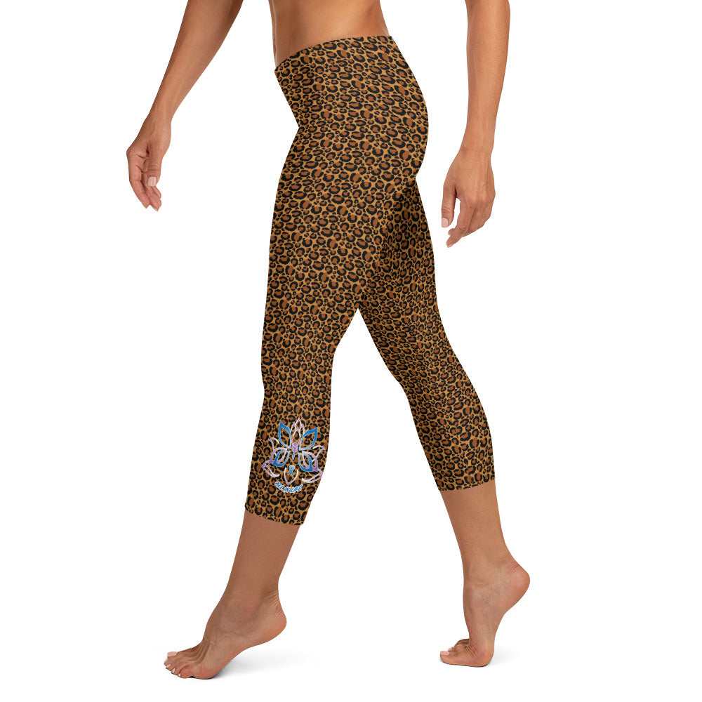 Kristin Zako embodies the "Wild & Free" spirit of her print capri leggings. These are printed in vivid color with a stylized cheetah print. The words, "WILD & FREE" are down the right leg and you'll find Kristin's logo on the lower left leg. Leopard style - left view.