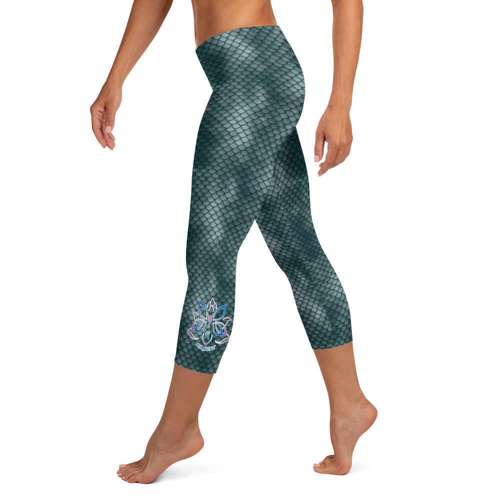 Kristin Zako embodies the "Wild & Free" spirit of her print capri leggings. These are printed in vivid color with a stylized cheetah print. The words, "WILD & FREE" are down the right leg and you'll find Kristin's logo on the lower left leg. Fish scale style - left view.