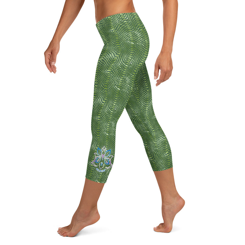 Kristin Zako embodies the "Wild & Free" spirit of her print capri leggings. These are printed in vivid color with a stylized cheetah print. The words, "WILD & FREE" are down the right leg and you'll find Kristin's logo on the lower left leg. Crocodile style - left view.