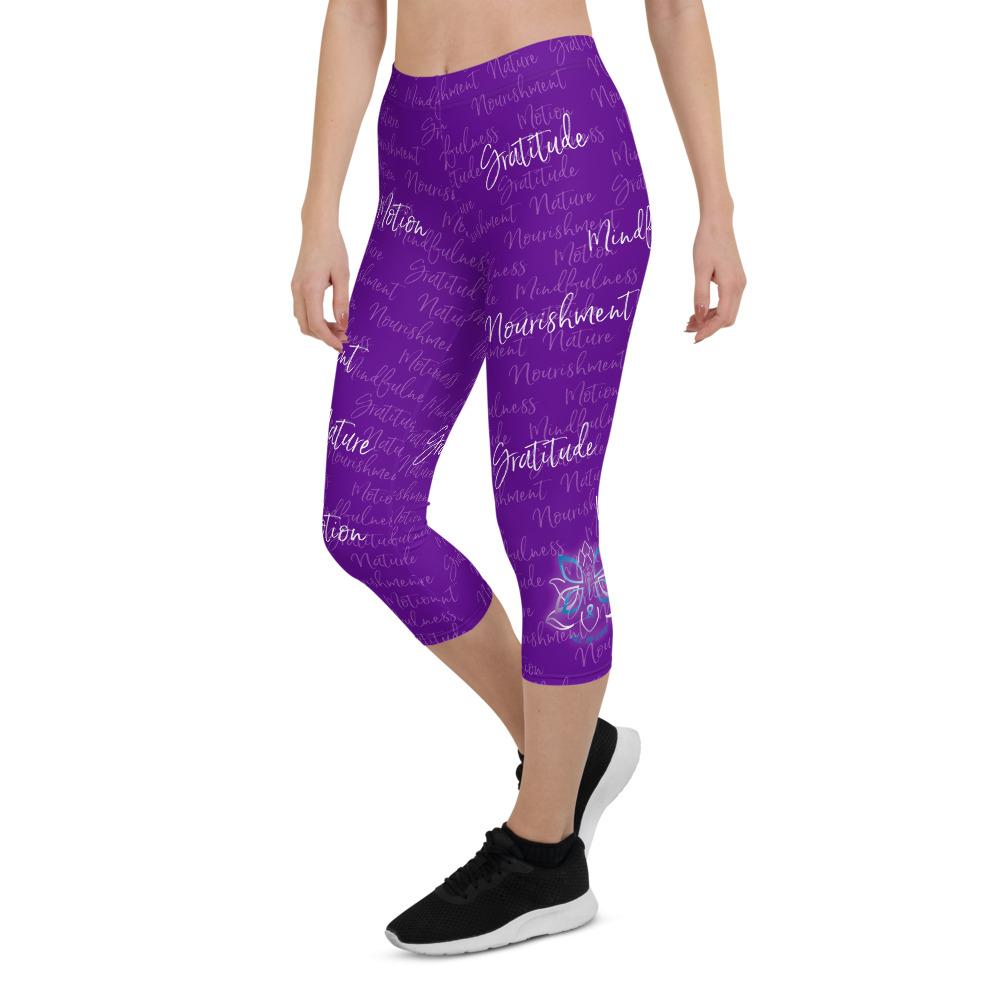 These Kristin Zako capri leggings are filled with her four pillars phrases and topped off with her logo on each side. They are super soft and comfortable. Shown in purple, front left view.
