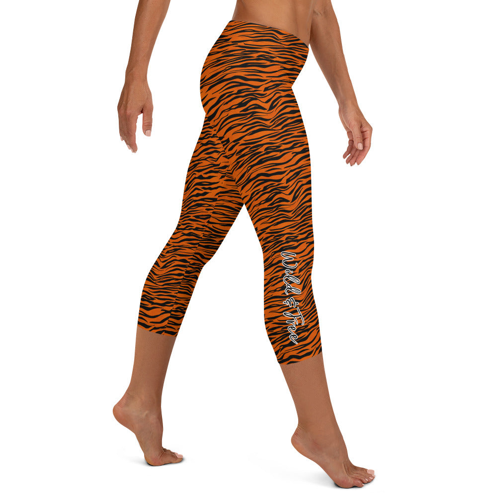 Kristin Zako embodies the "Wild & Free" spirit of her print capri leggings. These are printed in vivid color with a stylized cheetah print. The words, "WILD & FREE" are down the right leg and you'll find Kristin's logo on the lower left leg. Tiger style - Right view.