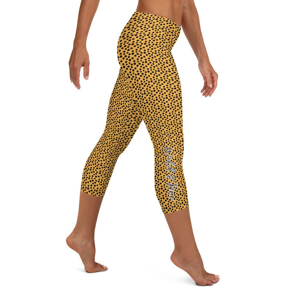 Kristin Zako embodies the "Wild & Free" spirit of her print capri leggings. These are printed in vivid color with a stylized cheetah print.  The words, "WILD & FREE" are down the right leg and you'll find Kristin's logo on the lower left leg. Cheetah style - Right view.
