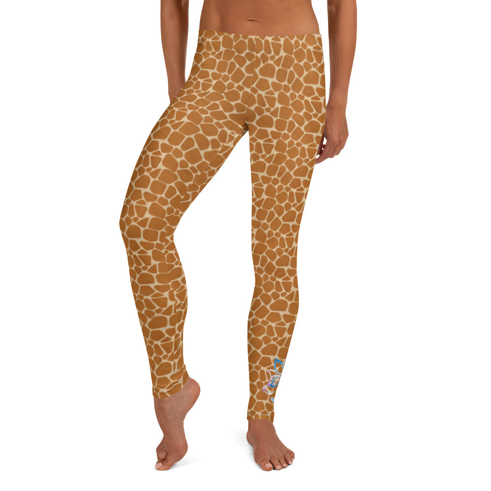 Kristin Zako embodies the "Wild & Free" spirit of her giraffe print leggings. These are printed in vivid color with a stylized giraffe print.  The words, "WILD & FREE" are down the right leg and you'll find Kristin's logo on the lower left leg. Front view.