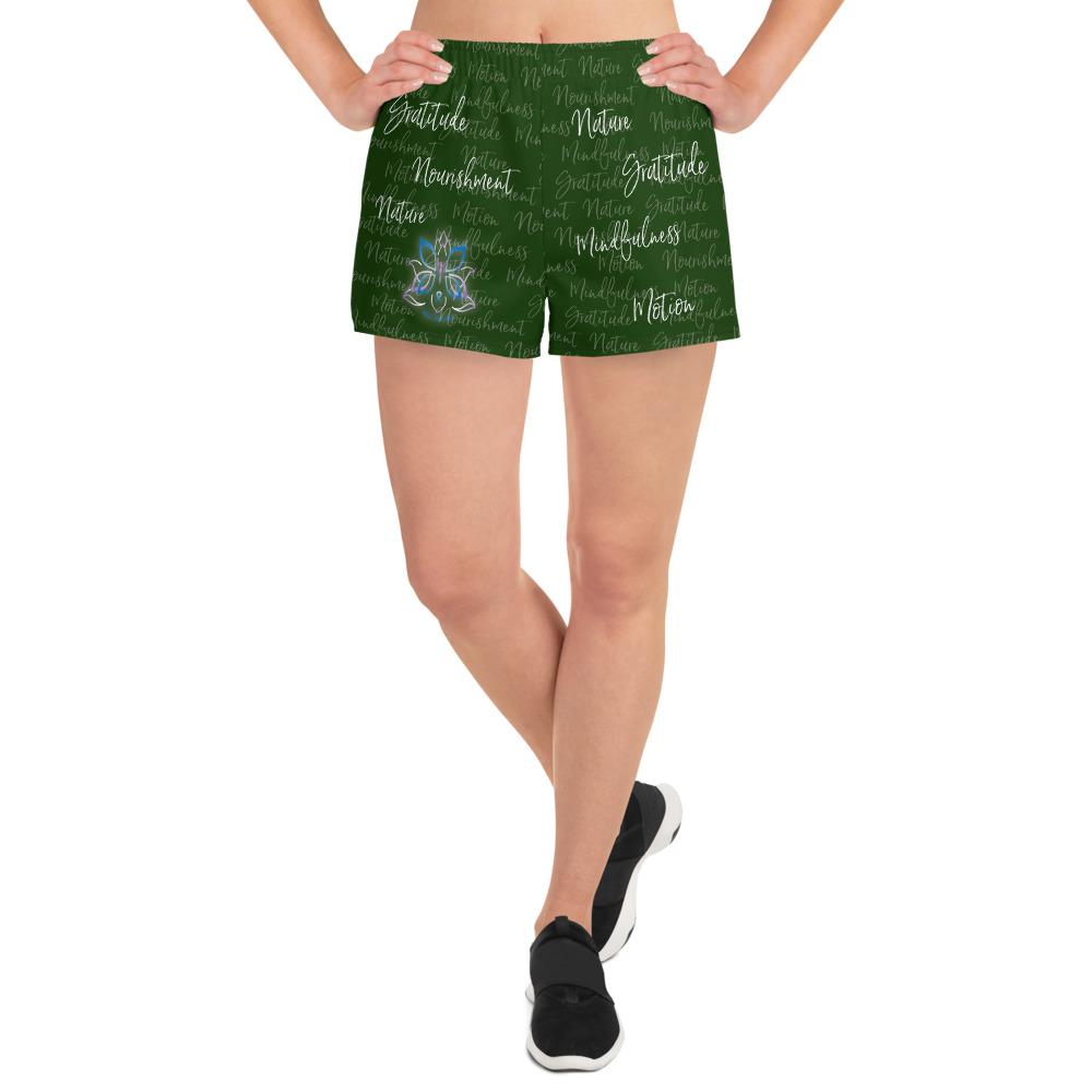 These athletic women's short shorts are so comfy and made from such a versatile fabric that you won't feel out of place at any sports event. The Kristin Zako print is filled with her four pillars phrases and topped off with her logo on the front right leg. Shown in green. Front view.