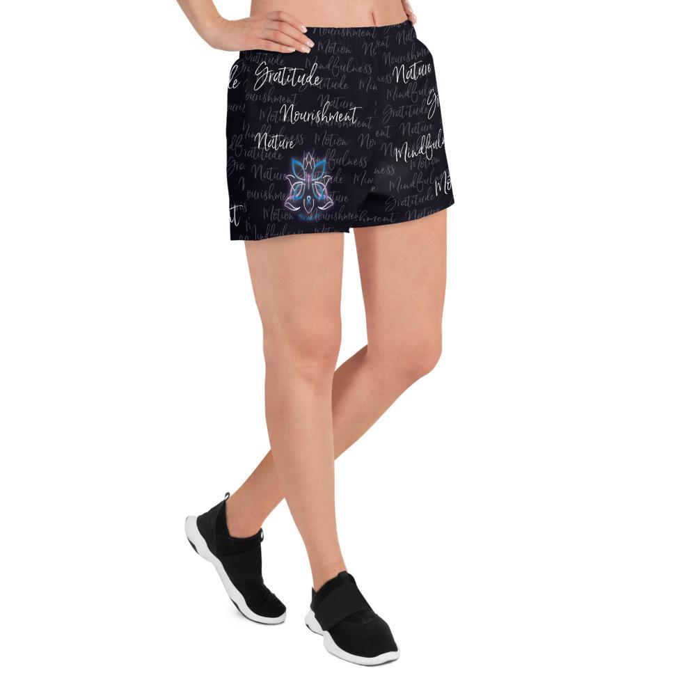 These athletic women's short shorts are so comfy and made from such a versatile fabric that you won't feel out of place at any sports event. The Kristin Zako print is filled with her four pillars phrases and topped off with her logo on the front right leg. Shown in black. Right view.