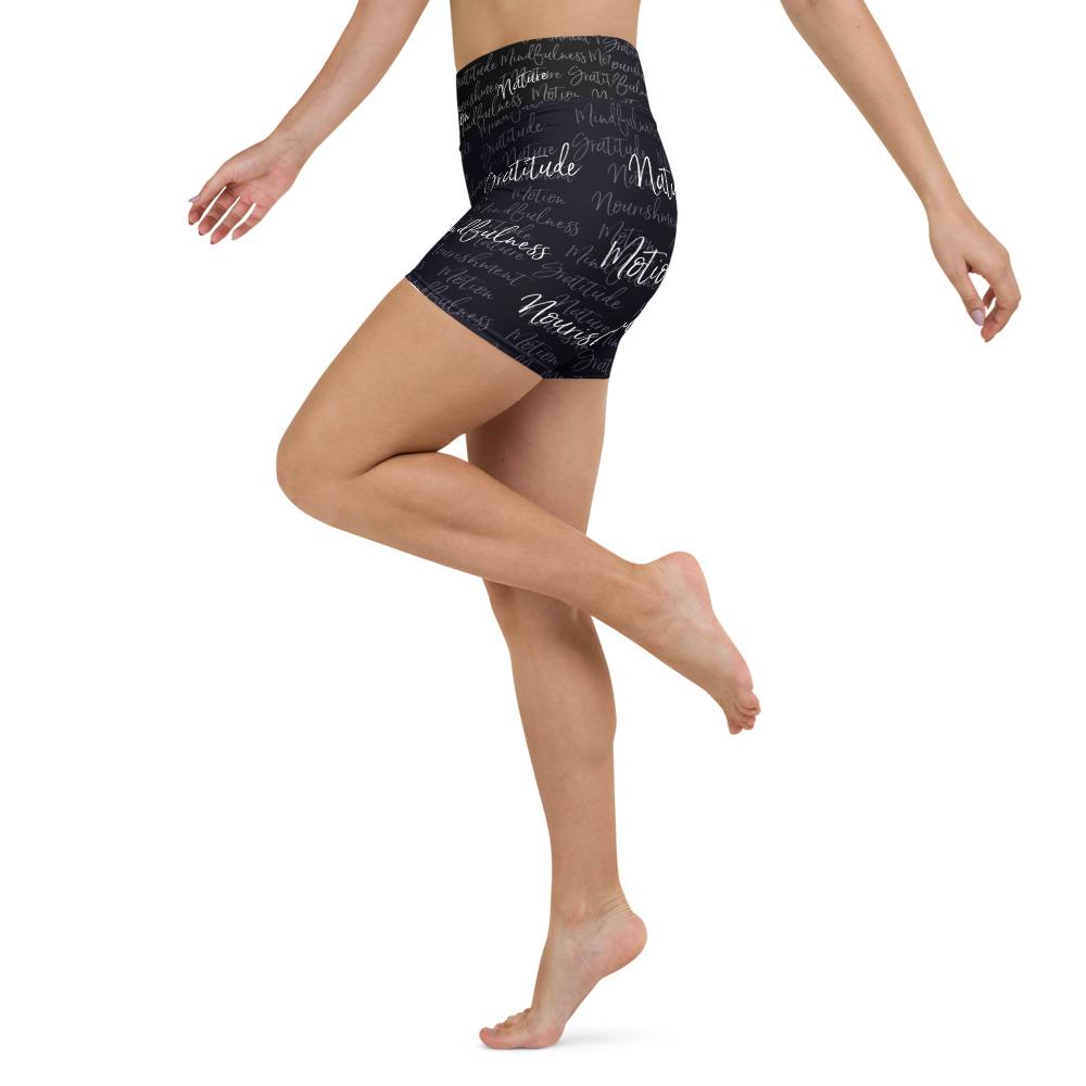 These yoga shorts have a body-flattering fit that will make you feel super comfortable even during the most intense workouts. They come with a high waistband and are made from soft microfiber yarn. The Kristin Zako print is filled with her four pillars phrases and topped off with her logo on the front right leg. Shown in black. Left view.