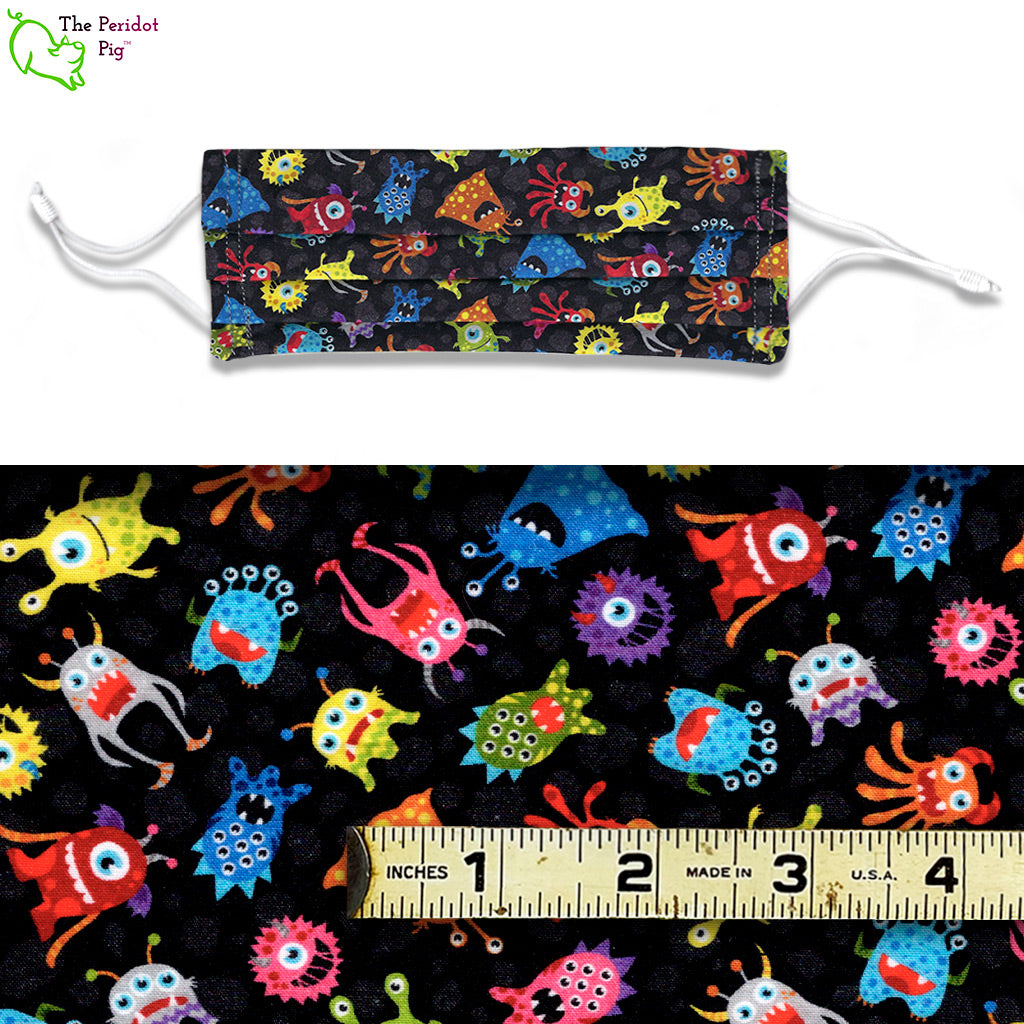 The Bug-Eyed Monsters fabric has a bunch of colorful BEMS floating in space. A colorful print on a black background. View shows a mask and a scale view of the fabric.