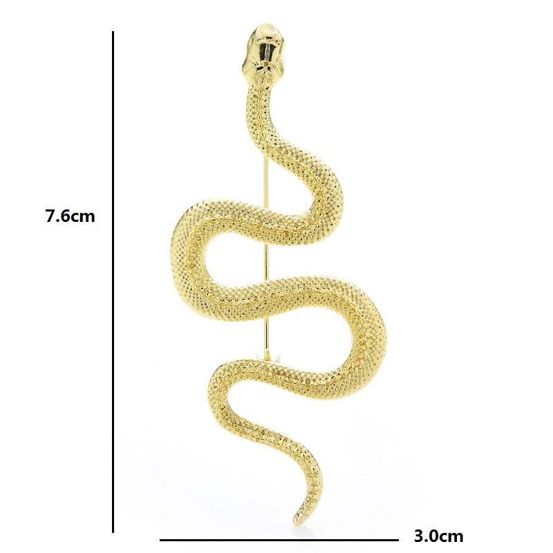 An elegant snake pin measuring at 3" in length in gold finish. Showing dimensions of 7.6 x 3 cm.
