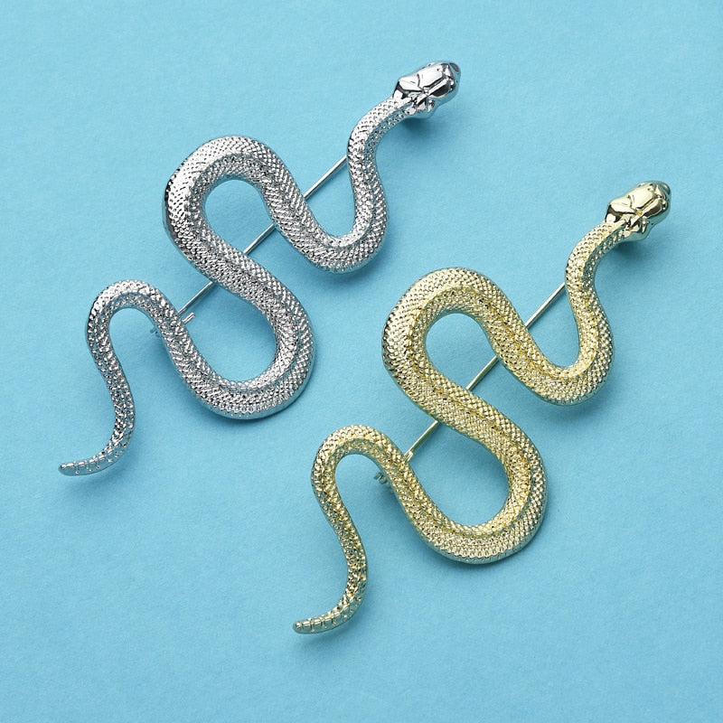 Image of an elegant snake pin measuring at 3" in length. shown in both gold and silver finishes.