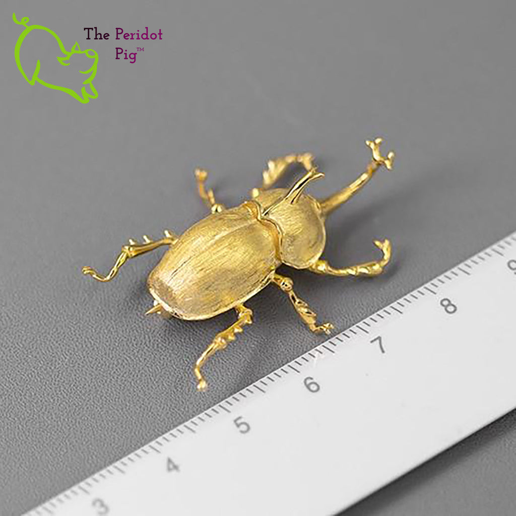 The detail on this amazing iNature rhinoceros beetle brooch is wonderful. Cast in 925 sterling silver and plated in 18K gold. Shown in gold, front view with ruler.