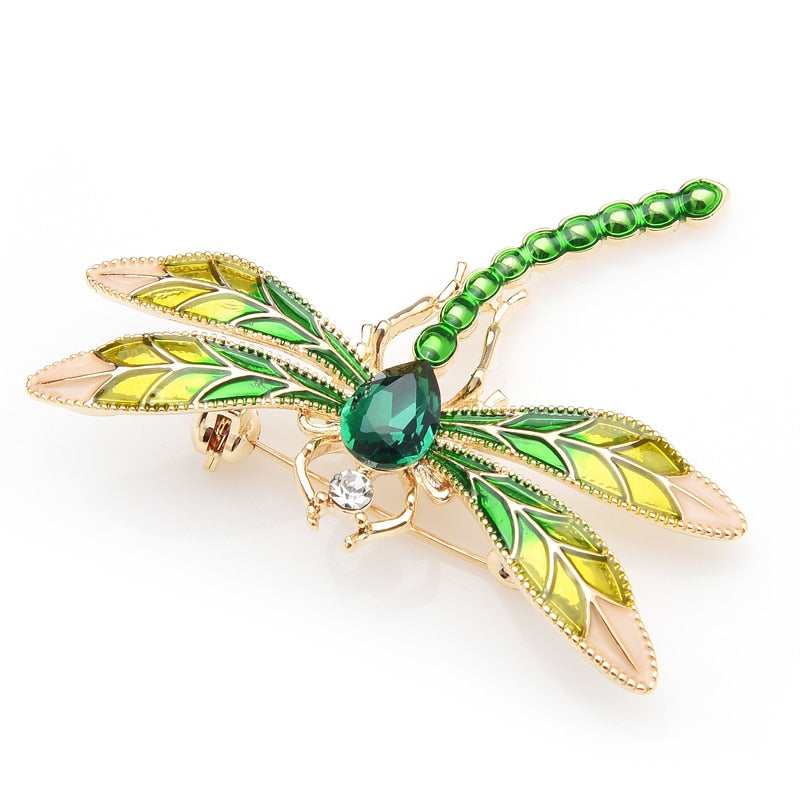 This delicate little dragonfly brooch is a shimmery green with a large green center rhinestone. It can be worn as a pin or attached to a necklace chain using the loop on the back. It's roughly 2" in each dimension. Front view.