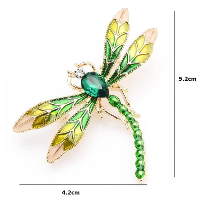 This delicate little dragonfly brooch is a shimmery green with a large green center rhinestone. It can be worn as a pin or attached to a necklace chain using the loop on the back. It's roughly 2" in each dimension. Dimensions shown as 4.2 x 5.2 cm